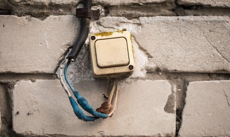 Instalación eléctrica antigua con mecanismo y cableado envejecidos