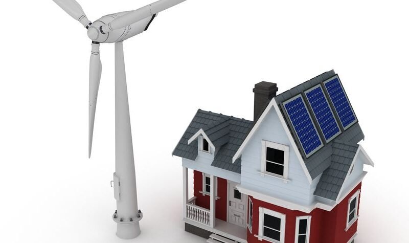 Minieólica vivienda con aerogenerador junto a una casa